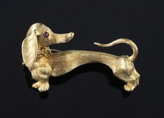 An 18ct gold and ruby set novelty brooch, modelled as dachshund, 1.5in.